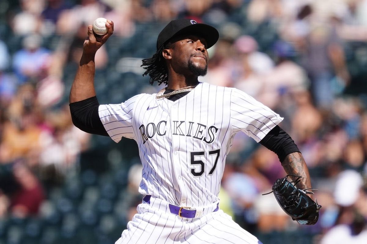 Aug 3, 2025; Denver, Colorado, USA; Colorado Rockies relief pitcher Angel Chivilli (57) delivers a pitch in the seventh inning against the Pittsburgh Pirates at Coors Field. Mandatory Credit: Ron Chenoy-Imagn Images