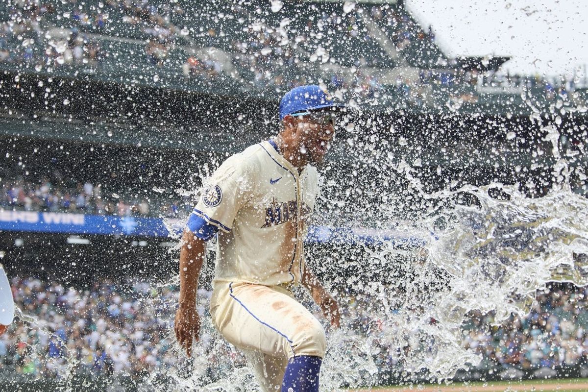 Aug 3, 2025; Seattle, Washington, USA; Seattle Mariners center fielder Julio Rodríguez (44) is doused with ice water after playing the Texas Rangers at T-Mobile Park. Mandatory Credit: John Froschauer-Imagn Images