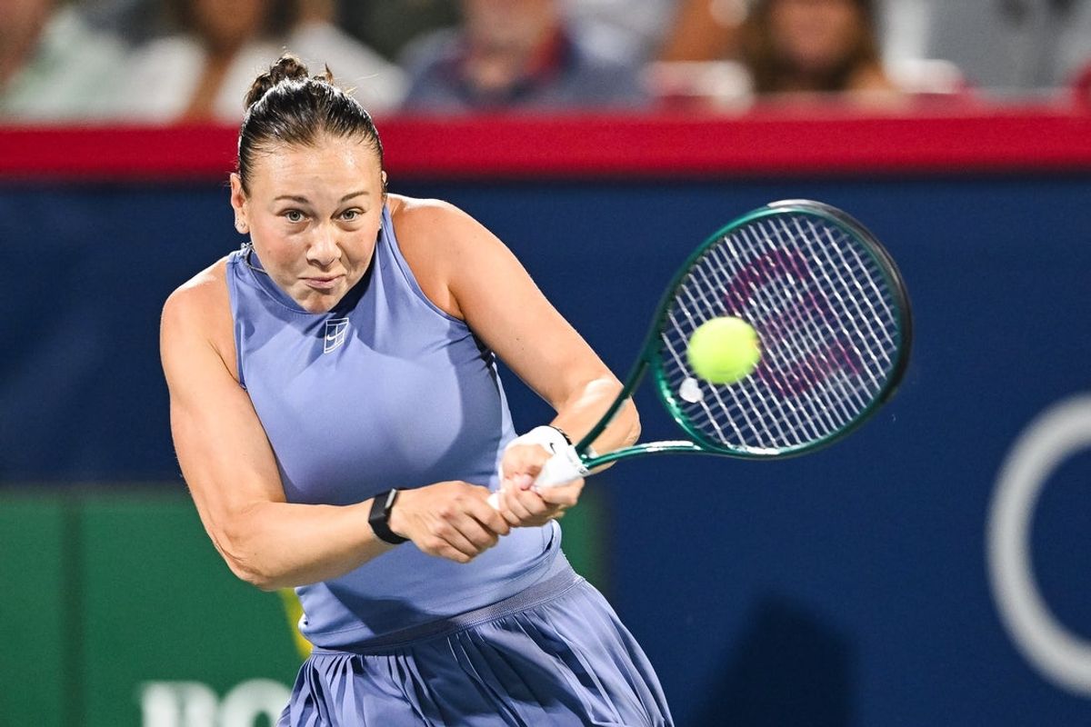 Aug 3, 2025; Montreal, QC, Canada; Amanda Anisimova (USA) returns the ball to Elina Svitolina (UKR) in fourth round play at IGA Stadium. Mandatory Credit: David Kirouac-Imagn Images