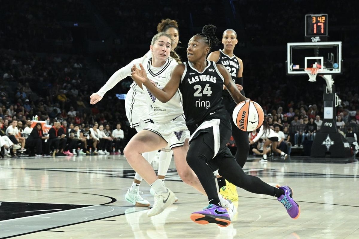 Aug 3, 2025; Las Vegas, Nevada, USA; Las Vegas Aces guard Jewell Loyd (24) drives past Golden State Valkyries guard Kate Martin (20) in the first quarter at Michelob Ultra Arena. Mandatory Credit: Candice Ward-Imagn Images