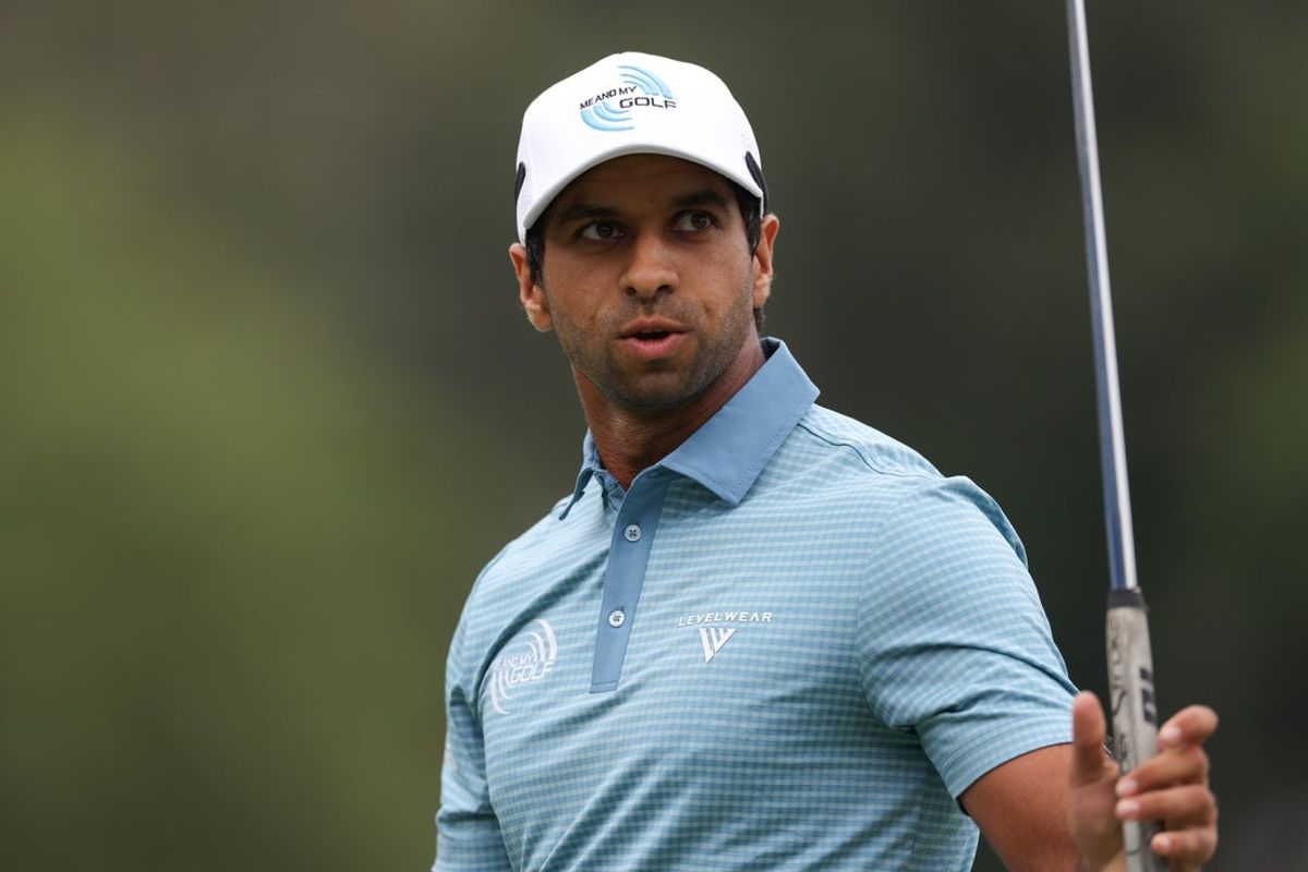 Aug 3, 2025; Greensboro, North Carolina, USA; Aaron Rai waves to the crowd after his putt on the 18th green during the final round of the Wyndham Championship golf tournament. Mandatory Credit: Allison Lawhon-Imagn Images