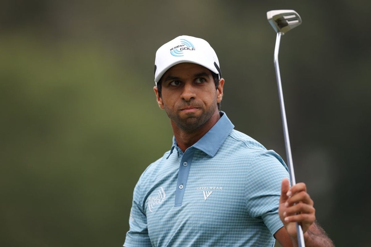 Aug 3, 2025; Greensboro, North Carolina, USA; Aaron Rai waves to the crowd after his putt on the 18th green during the final round of the Wyndham Championship golf tournament. Mandatory Credit: Allison Lawhon-Imagn Images