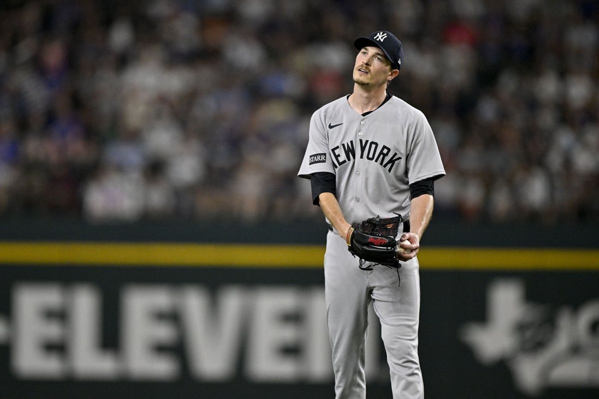 Aug 4, 2025; Arlington, Texas, USA; New York Yankees starting pitcher Max Fried (54) reacts to giving up the tying run to the Texas Rangers during the second inning at Globe Life Field. Mandatory Credit: Jerome Miron-Imagn Images