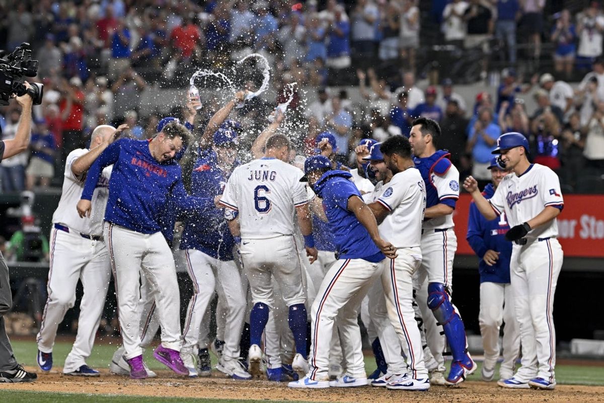 Aug 4, 2025; Arlington, Texas, USA; Texas Rangers designated hitter Josh Jung (6) celebrates with his team after Jung hits a game winning home run against the New York Yankees during the tenth inning at Globe Life Field. Mandatory Credit: Jerome Miron-Imagn Images