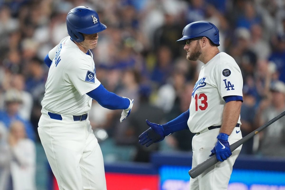 Aug 4, 2025; Los Angeles, California, USA;  Los Angeles Dodgers first baseman Freddie Freeman (5) is congratulated by third baseman Max Muncy (13) after homering to right center field in the bottom of the fourth inning in an MLB game against the St. Louis Cardinals at Dodger Stadium. Mandatory Credit: Kirby Lee-Imagn Images