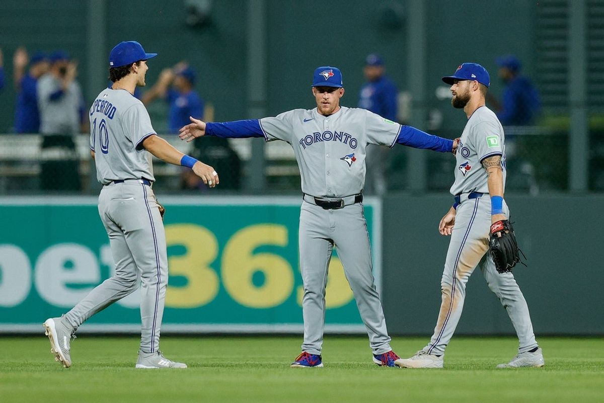 Aug 4, 2025; Denver, Colorado, USA; Toronto Blue Jays left fielder Joey Loperfido (10) and center fielder Myles Straw (3) and right fielder Nathan Lukes (38) celebrate after the game against the Colorado Rockies at Coors Field. Mandatory Credit: Isaiah J. Downing-Imagn Images