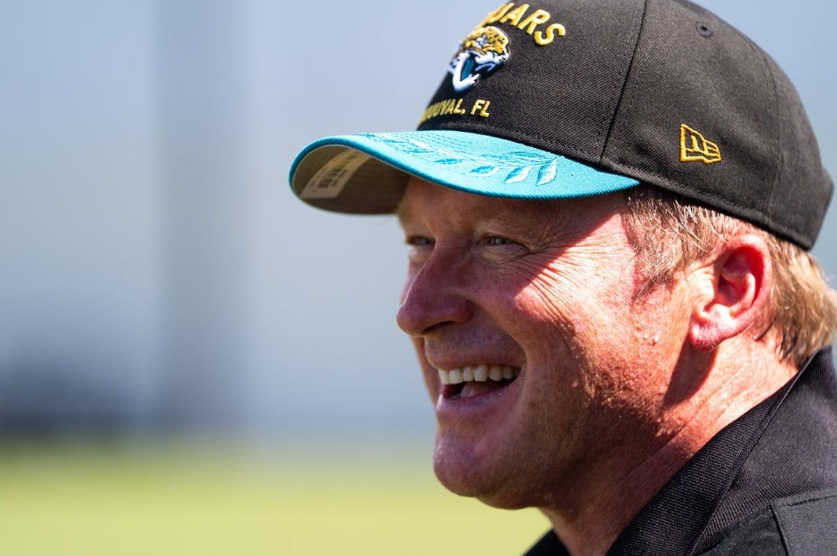 Former NFL coach Jon Gruden have a laugh while attending an NFL training camp session at the Miller Electric Center, Tuesday, Aug. 5, 2025, in Jacksonville, Fla. [Doug Engle/Florida Times-Union]