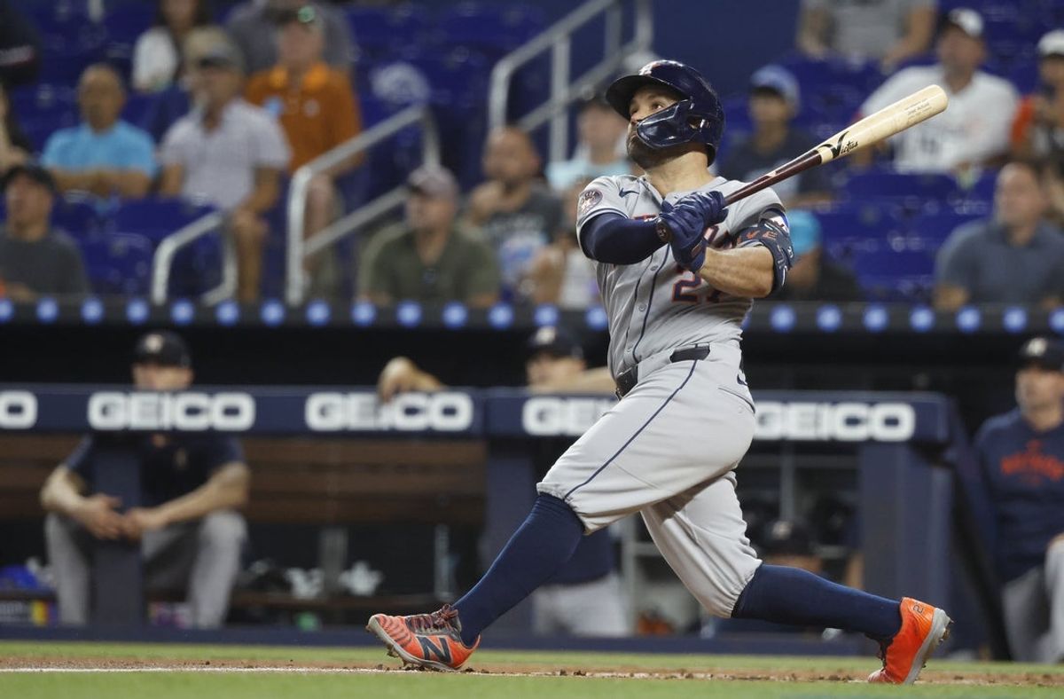 Aug 5, 2025; Miami, Florida, USA;  Houston Astros outfielder Jose Altuve (27) follows through on his two run home run against the Miami Marlins during the first inning at loanDepot Park. Mandatory Credit: Rhona Wise-Imagn Images