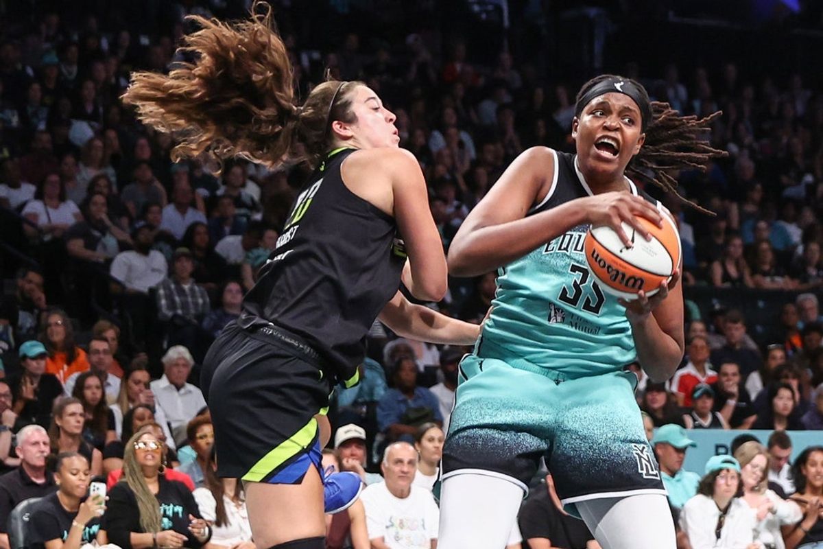Aug 5, 2025; Brooklyn, New York, USA;  New York Liberty center Jonquel Jones (35) grabs a rebound away from Dallas Wings forward Maddy Siegrist (20) in the second quarter at Barclays Center. Mandatory Credit: Wendell Cruz-Imagn Images