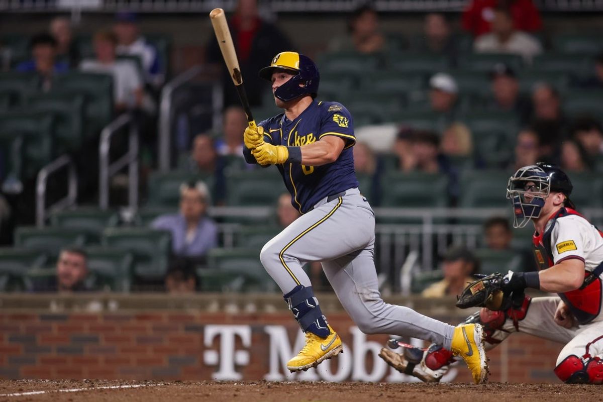 Aug 5, 2025; Atlanta, Georgia, USA; Milwaukee Brewers right fielder Isaac Collins (6) hits a triple against the Atlanta Braves in the XXX inning at Truist Park. Mandatory Credit: Brett Davis-Imagn Images