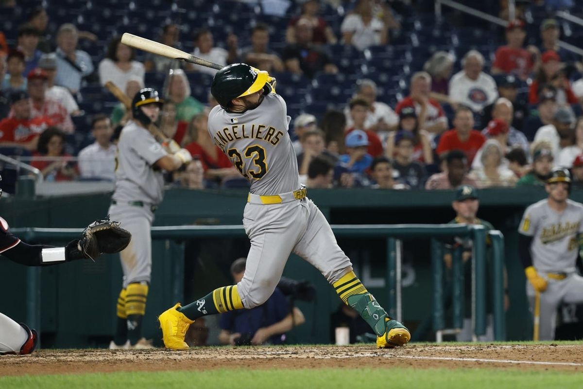 Aug 5, 2025; Washington, District of Columbia, USA; Athletics catcher Shea Langeliers (23) hits a home run against the Washington Nationals during the seventh inning at Nationals Park. Mandatory Credit: Geoff Burke-Imagn Images