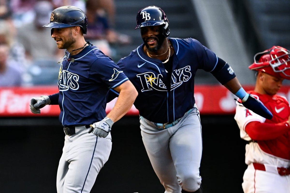 Aug 5, 2025; Anaheim, California, USA; Tampa Bay Rays first baseman Yandy Diaz (right) celebrates a two-run home run by second baseman Brandon Lowe (8) during the fourth inning against the Los Angeles Angels at Angel Stadium of Anaheim. Mandatory Credit: Kelvin Kuo-Imagn Images