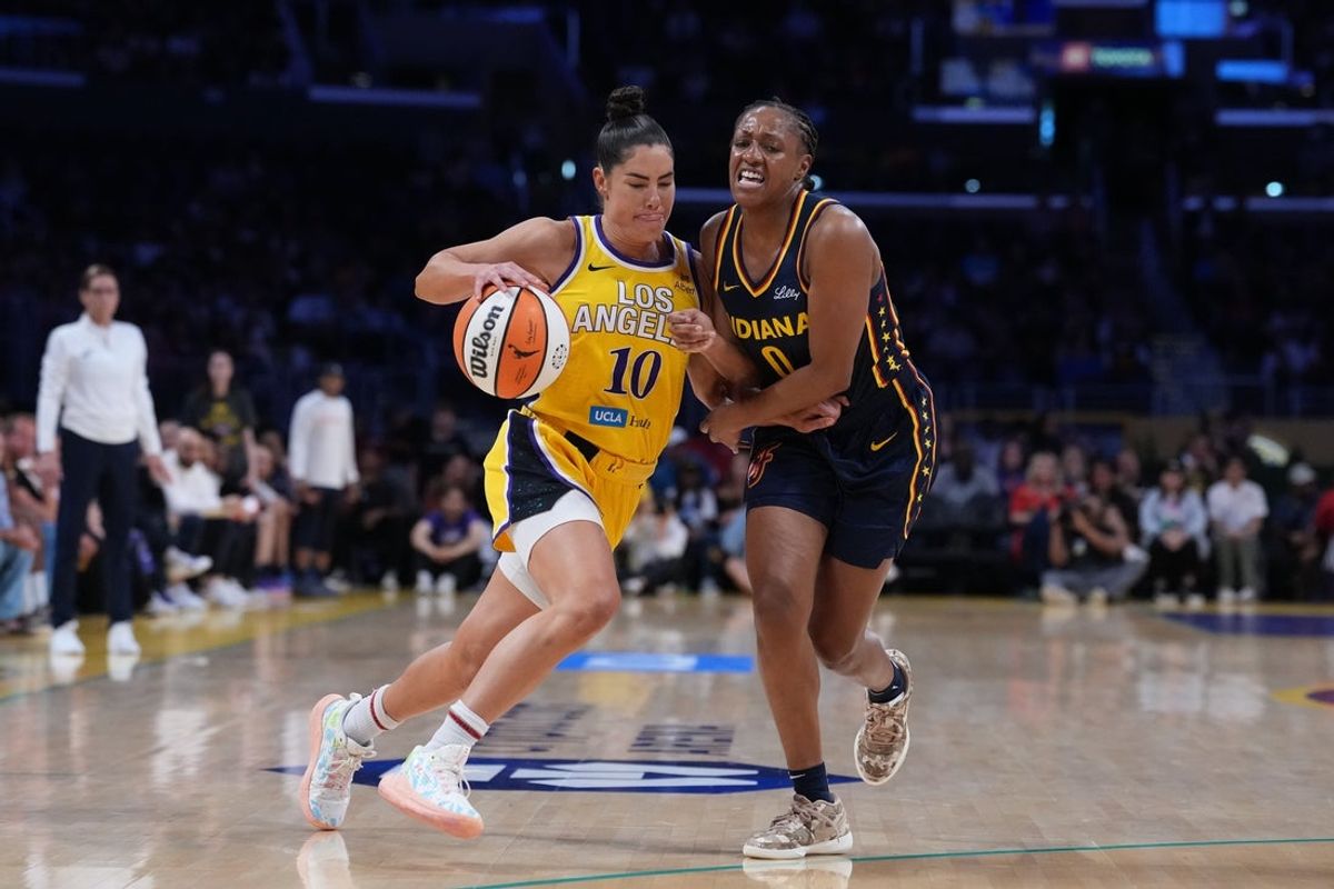 Aug 5, 2025; Los Angeles, California, USA; LA Sparks guard Kelsey Plum (10) drives to the basket while defended by Indiana Fever guard Kelsey Mitchell (0) in the first half at Crypto.com Arena. Mandatory Credit: Kirby Lee-Imagn Images
