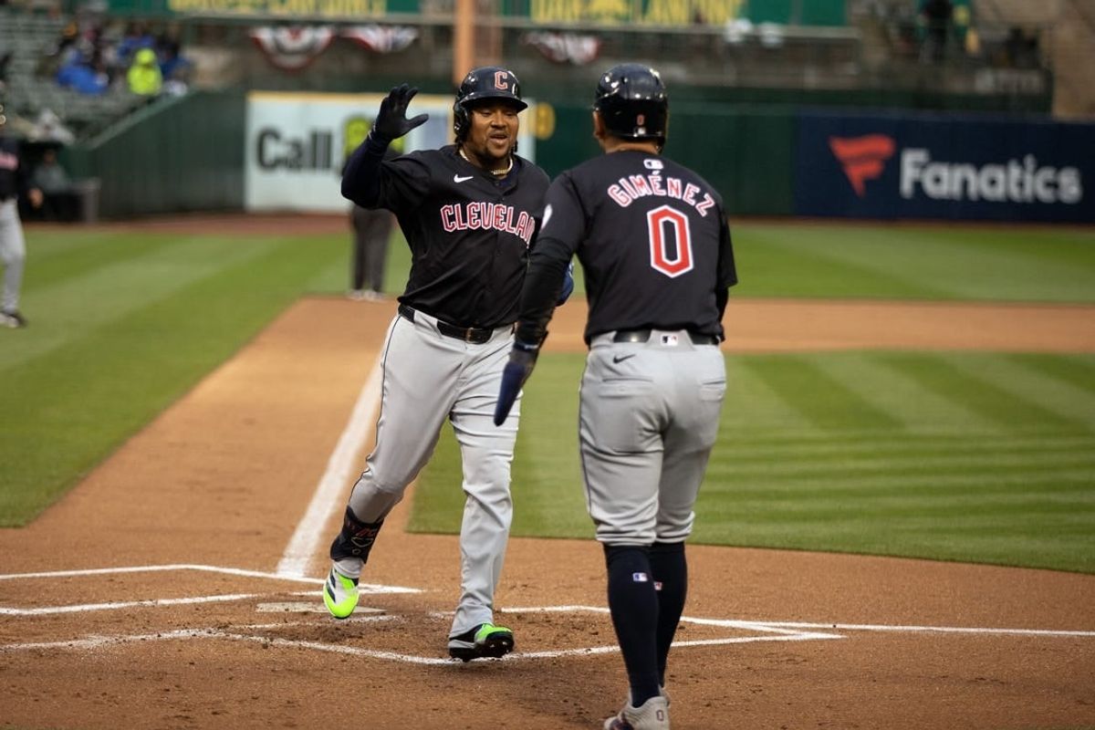 Mar 29, 2024; Oakland, California, USA; Cleveland Guardians third baseman José Ramírez (11) is greeted by teammate Andrés Giménez (0) after hitting a two-run home run against the Oakland Athletics during the first inning at Oakland-Alameda County Coliseum.