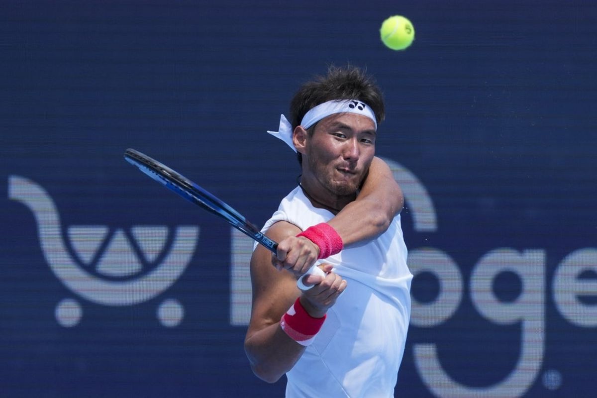Aug 7, 2025; Cincinnati, OH, USA; Yunchaokete Bu (CHN) returns a shot against Joao Fonseca (BRA) during the Cincinnati Open at the Lindner Family Tennis Center. Mandatory Credit: Aaron Doster-Imagn Images