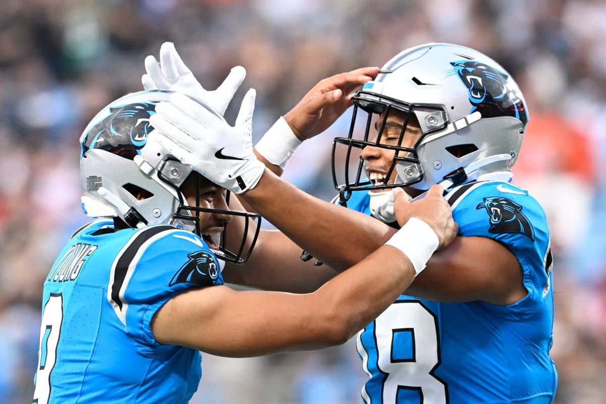 Aug 8, 2025; Charlotte, North Carolina, USA; Carolina Panthers wide receiver Jalen Coker (18) celebrates with quarterback Bryce Young (9) after a touchdown catch in the first quarter at Bank of America Stadium. Mandatory Credit: Bob Donnan-Imagn Images