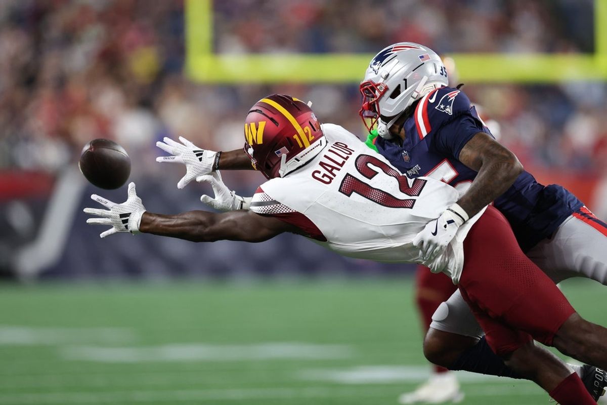 Aug 8, 2025; Foxborough, Massachusetts, USA; New England Patriots cornerback Miles Battle (35) breaks up a pass to Washington Commanders receiver Michael Gallup (12) during the first half at Gillette Stadium. Mandatory Credit: Paul Rutherford-Imagn Images