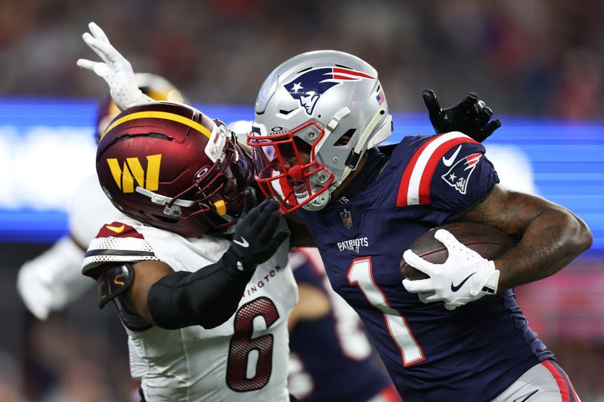 Aug 8, 2025; Foxborough, Massachusetts, USA; Washington Commanders cornerback Noah Igbinoghene (6) tackles New England Patriots receiver Ja'Lynn Polk (1) during the first half at Gillette Stadium. Mandatory Credit: Paul Rutherford-Imagn Images