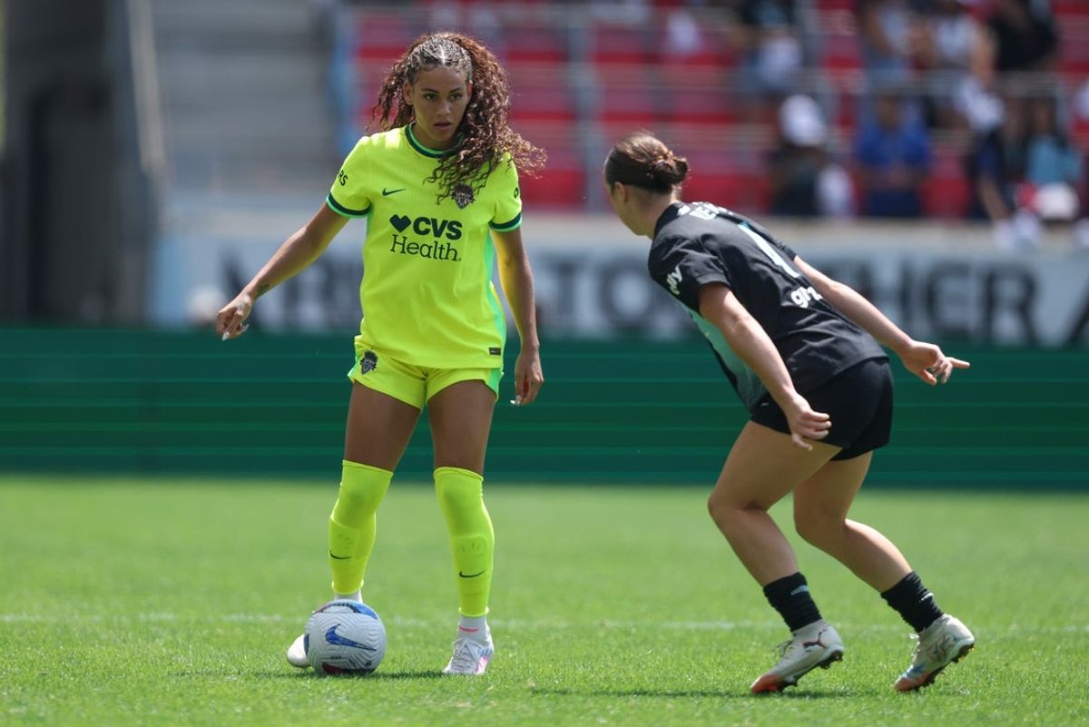 Aug 9, 2025; Harrison, New Jersey, USA; Washington Spirit forward Trinity Rodman (2) controls the ball against Gotham FC defender Lilly Reale (4) during the second half at Sports Illustrated Stadium. Mandatory Credit: Vincent Carchietta-Imagn Images