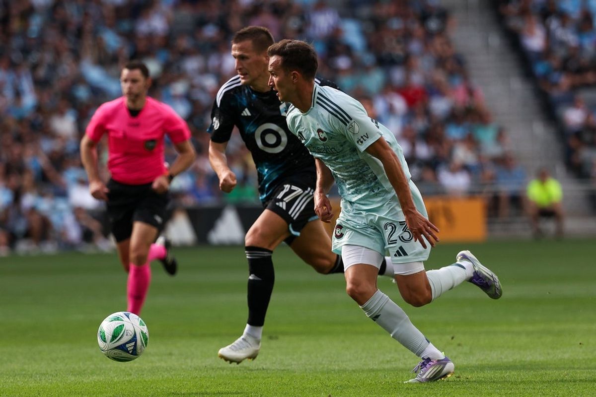 Aug 10, 2025; Saint Paul, Minnesota, USA; Colorado Rapids midfielder Cole Bassett (23) dribbles the ball as Minnesota United midfielder Robin Lod (17) defends during the first half at Allianz Field. Mandatory Credit: Matt Krohn-Imagn Images