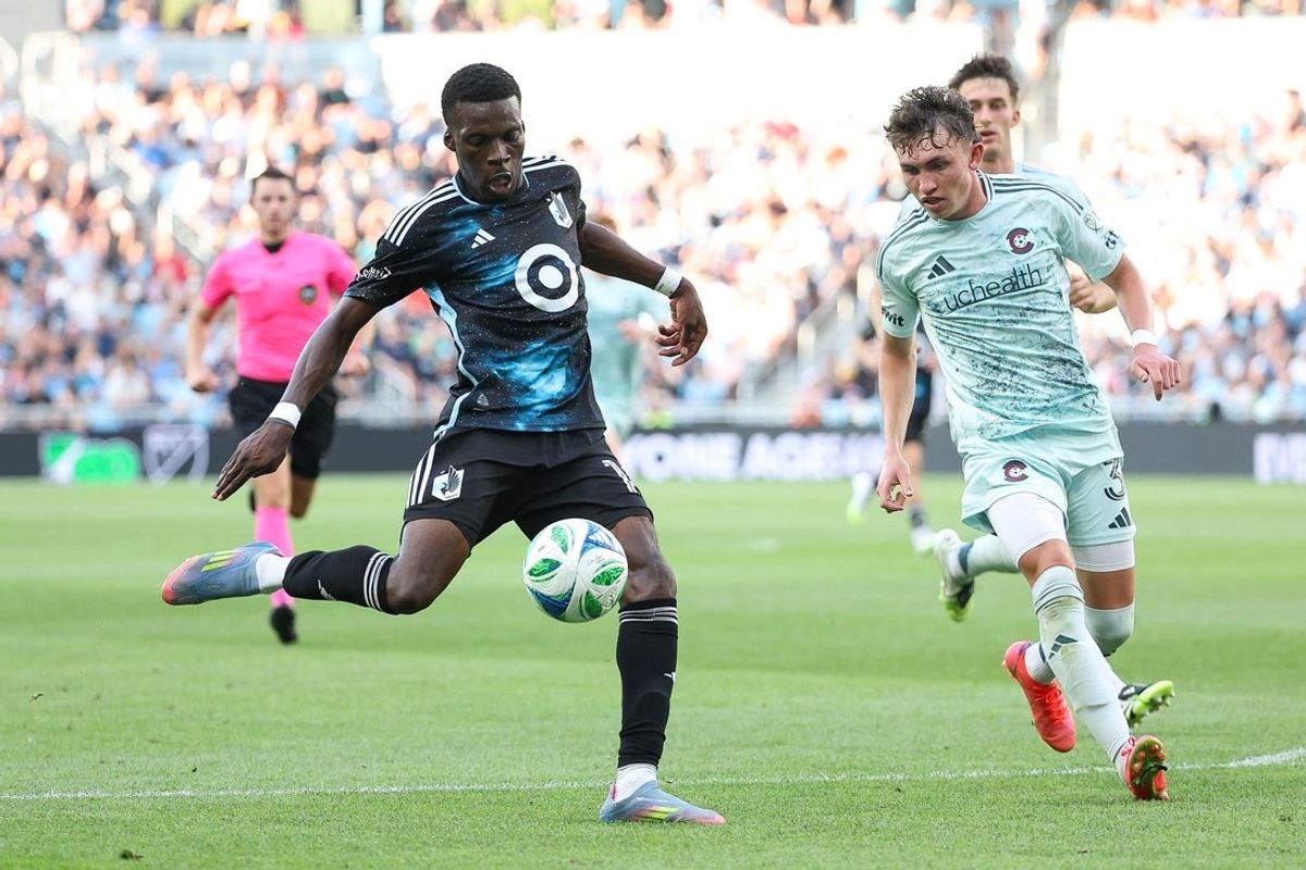 Aug 10, 2025; Saint Paul, Minnesota, USA; Minnesota United forward Tani Oluwaseyi (14) shoots as Colorado Rapids defender Sam Vines (3) defends during the second half at Allianz Field. Mandatory Credit: Matt Krohn-Imagn Images