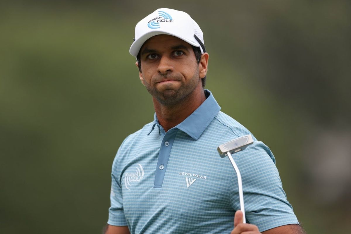 Aug 3, 2025; Greensboro, North Carolina, USA; Aaron Rai waves to the crowd after his final putt on the 18th green during the final round of the Wyndham Championship golf tournament. Mandatory Credit: Allison Lawhon-Imagn Images