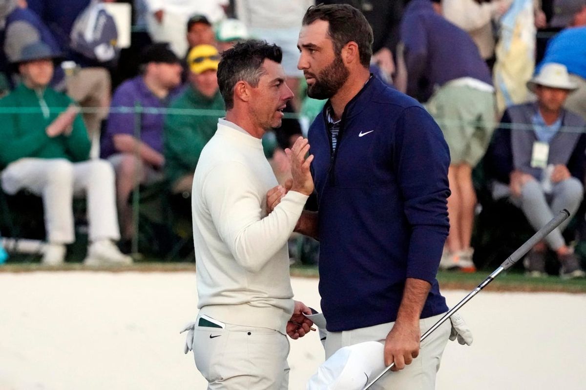 Rory McIlroy shakes hands with Scott Scheffler on the 18th green during the second round of the Masters Tournament at Augusta National Golf Club on April 12, 2024.