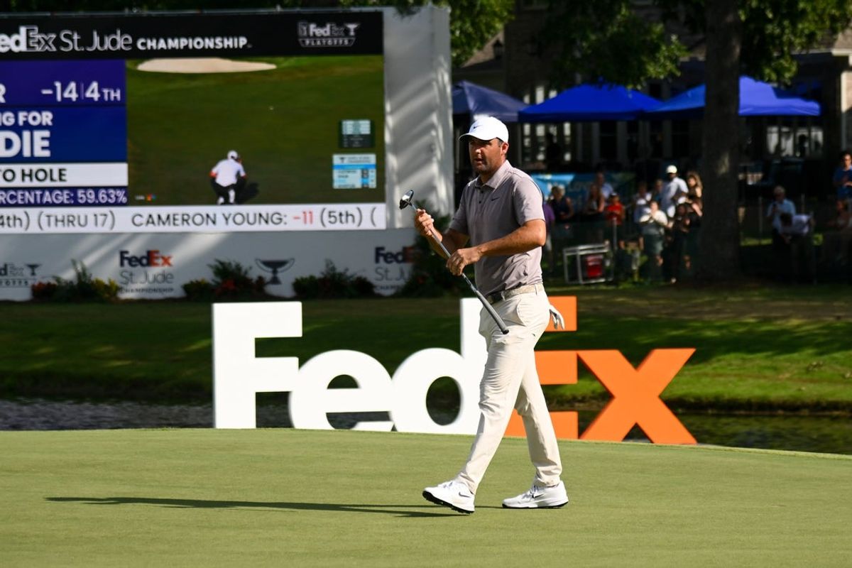 Aug 10, 2025; Memphis, Tennessee, USA; Scottie Scheffler putts on the 18th green during the final round of the FedEx St. Jude Championship golf. Mandatory Credit: Steve Roberts-Imagn Images