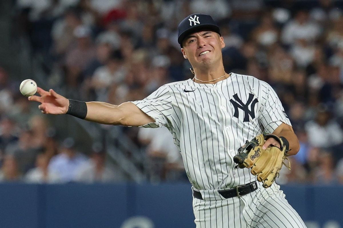 Aug 12, 2025; Bronx, New York, USA; New York Yankees shortstop Anthony Volpe (11) throws the ball first base for an out during the sixth inning at Yankee Stadium. Mandatory Credit: Vincent Carchietta-Imagn Images