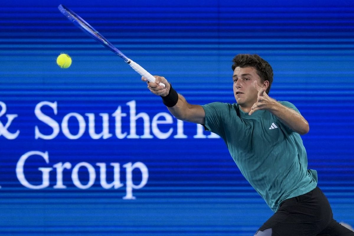 Aug 13, 2025; Cincinnati, OH, USA;  Luca Nardi (ITA) returns a shot against Carlos Alcaraz (ESP) during the Cincinnati Open at the Lindner Family Tennis Center. Mandatory Credit: Aaron Doster-Imagn Images