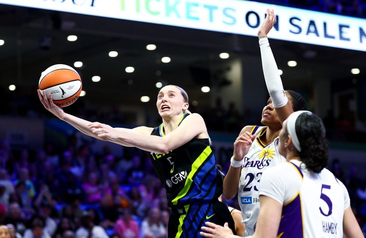 Aug 15, 2025; Arlington, Texas, USA;  Dallas Wings guard Paige Bueckers (5) shoots past Los Angeles Sparks forward Azura Stevens (23) and Los Angeles Sparks forward Dearica Hamby (5) during the second half at College Park Center. Mandatory Credit: Kevin Jairaj-Imagn Images