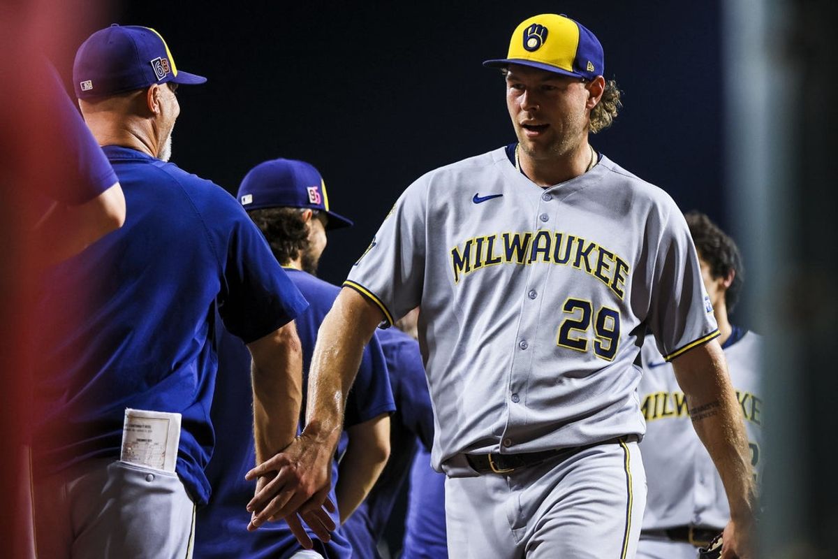 Aug 15, 2025; Cincinnati, Ohio, USA; Milwaukee Brewers relief pitcher Trevor Megill (29) high fives teammates after the victory over the Cincinnati Reds at Great American Ball Park. Mandatory Credit: Katie Stratman-Imagn Images