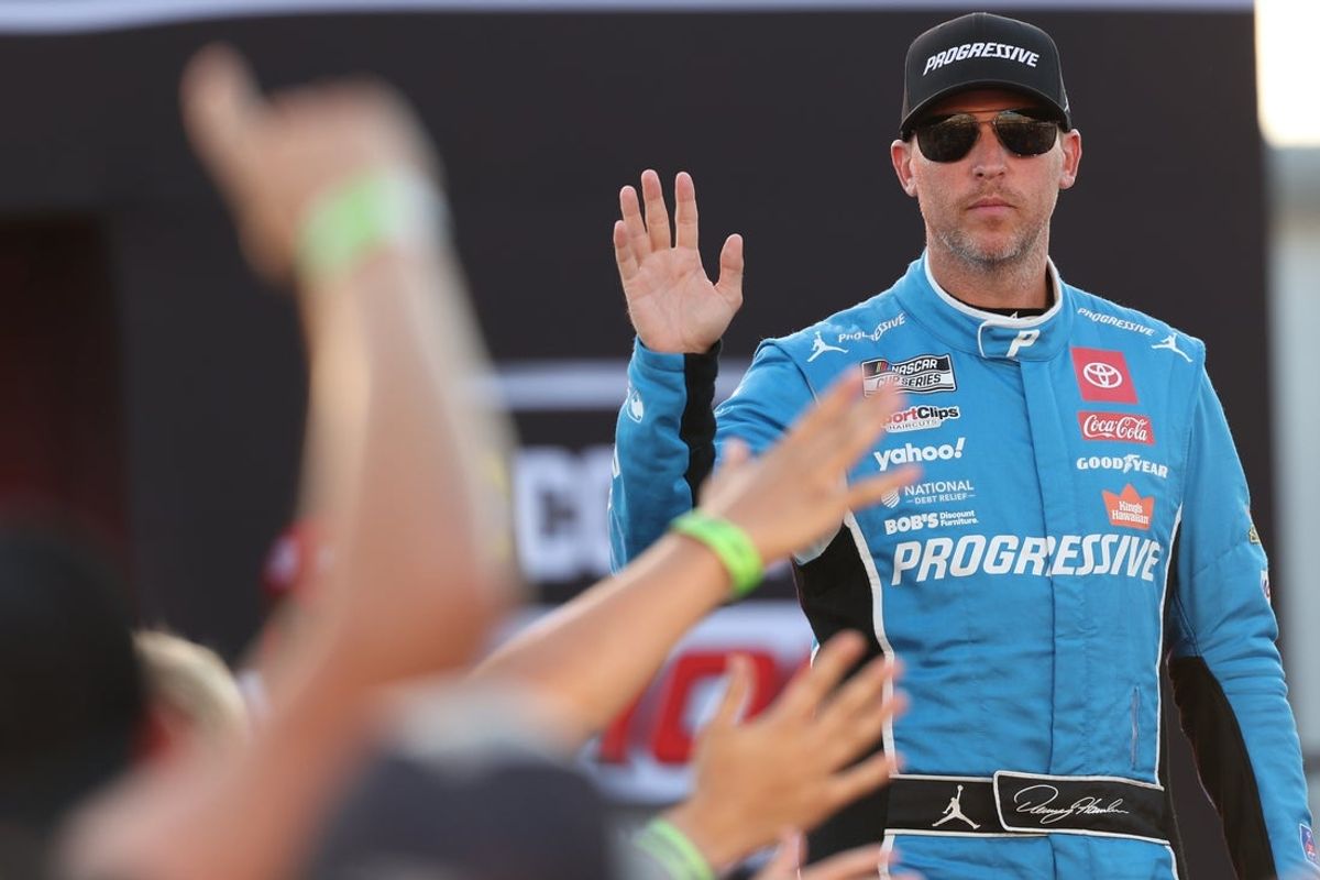 Aug 16, 2025; Richmond, Virginia, USA; NASCAR Cup Series driver Denny Hamlin (11) waves to fans during driver introductions prior to the NASCAR Cup Series Cook Out 400 at Richmond Raceway. Mandatory Credit: Amber Searls-Imagn Images