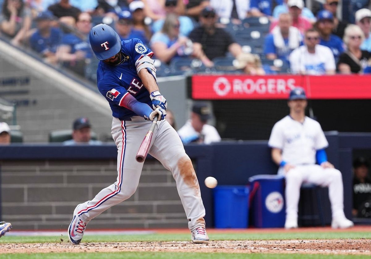 Aug 17, 2025; Toronto, Ontario, CAN; Texas Rangers second baseman Marcus Semien (2) hits a single against the Toronto Blue Jays during the seventh inning at Rogers Centre. Mandatory Credit: Nick Turchiaro-Imagn Imageses