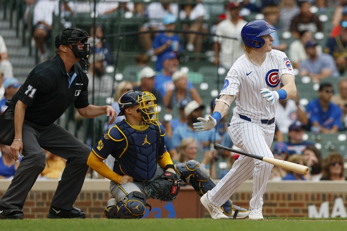 Aug 19, 2025; Chicago, Illinois, USA; Chicago Cubs right fielder Owen Caissie (19) hits a solo home run against the Milwaukee Brewers during the sixth inning of the game one of the doubleheader at Wrigley Field. Mandatory Credit: Kamil Krzaczynski-Imagn Images