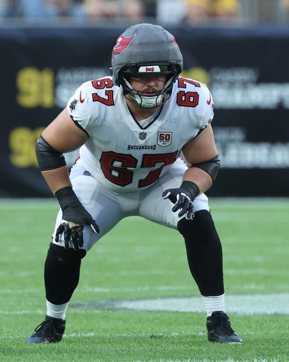 Aug 16, 2025; Pittsburgh, Pennsylvania, USA;  Tampa Bay Buccaneers offensive tackle Luke Goedeke (67) at the line of scrimmage against the Pittsburgh Steelers during the first quarter at Acrisure Stadium. Mandatory Credit: Charles LeClaire-Imagn Images