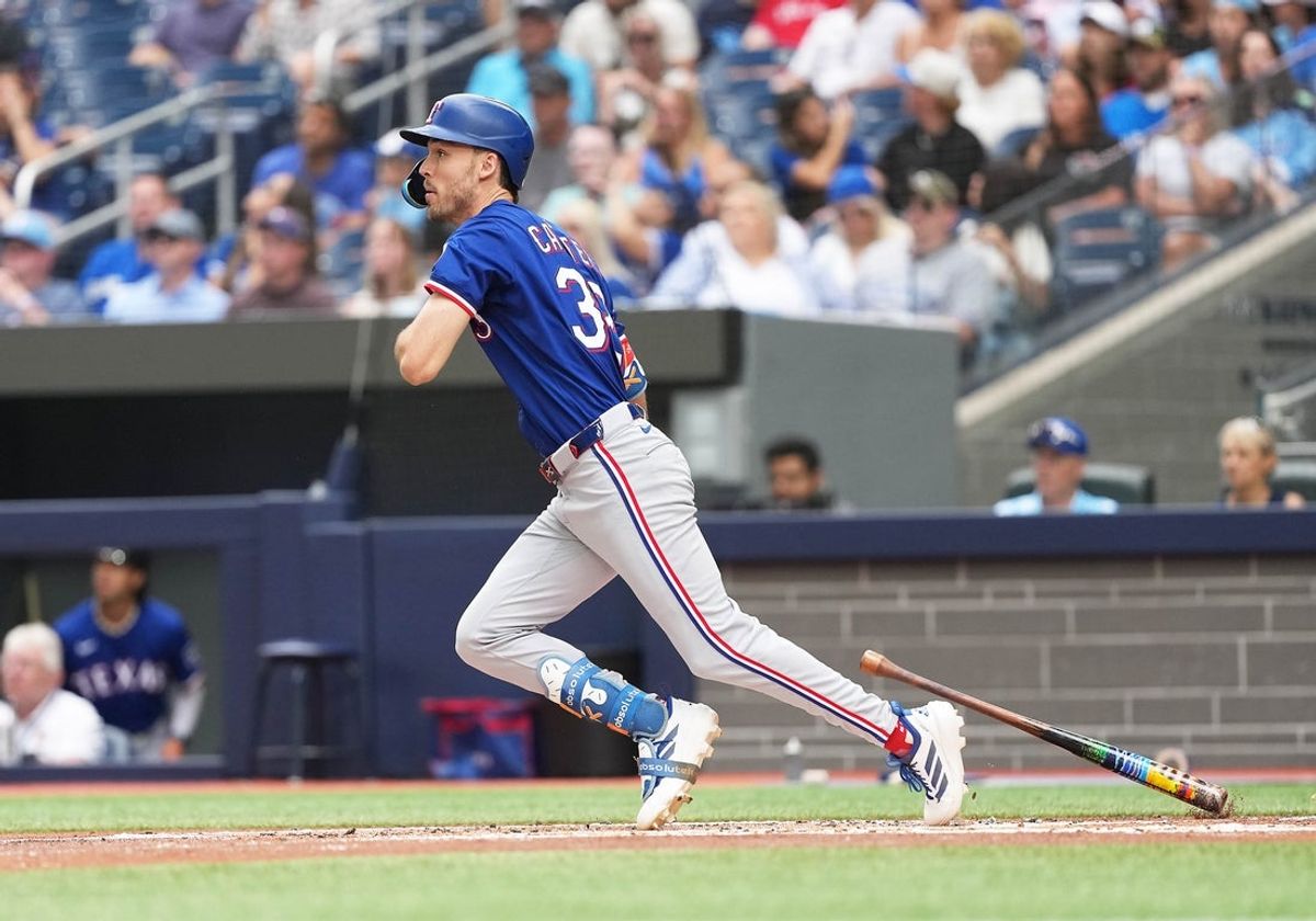 Aug 17, 2025; Toronto, Ontario, CAN; Texas Rangers centre fielder Evan Carter (32) reacts after hitting a fly ball to centre field against the Toronto Blue Jays during the second inning at Rogers Centre. Mandatory Credit: Nick Turchiaro-Imagn Imageses