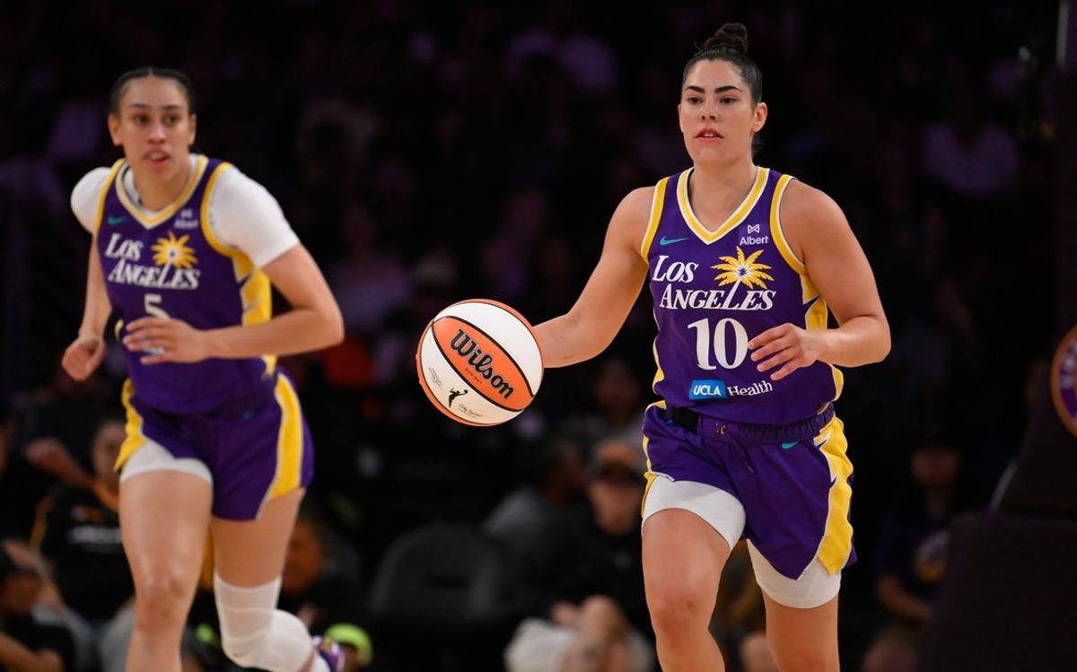 Aug 10, 2025; Los Angeles, California, USA; Los Angeles Sparks guard Kelsey Plum (10) dribbles the ball up court flanked by Los Angeles Sparks forward Dearica Hamby (5) during a WNBA game against the Seattle Storm at Crypto.com Arena. Mandatory Credit: Robert Hanashiro-Imagn Images
