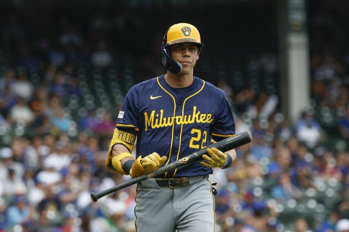 Aug 19, 2025; Chicago, Illinois, USA; Milwaukee Brewers designated hitter Christian Yelich (22) reacts after striking out against the Chicago Cubs during the first inning of the game one of the doubleheader at Wrigley Field. Mandatory Credit: Kamil Krzaczynski-Imagn Images