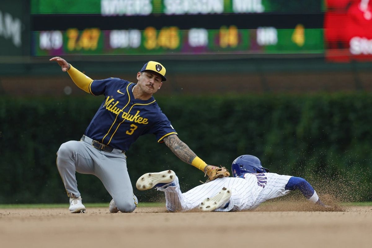 Aug 19, 2025; Chicago, Illinois, USA; Milwaukee Brewers shortstop Joey Ortiz (3) tags out Chicago Cubs center fielder Pete Crow-Armstrong (4) at second base during the eight inning of the game one of the doubleheader at Wrigley Field. Mandatory Credit: Kamil Krzaczynski-Imagn Images
