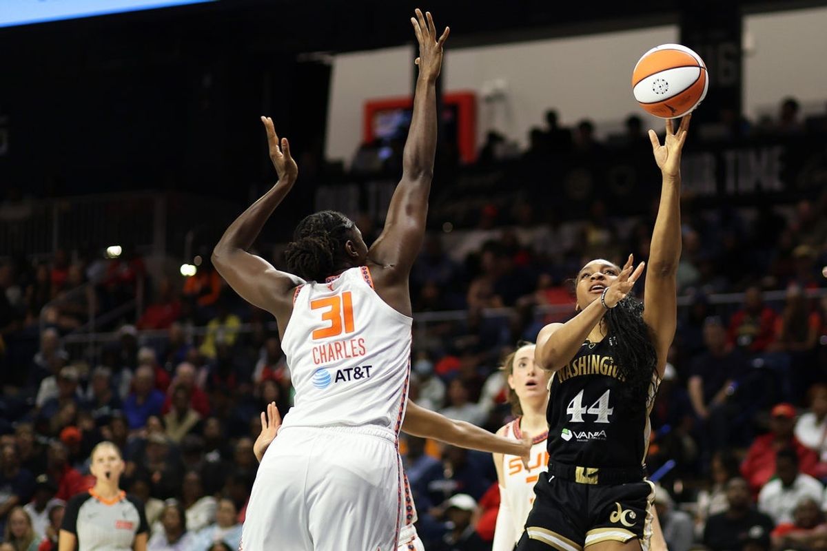 Aug 19, 2025; Washington, District of Columbia, USA; Washington Mystics forward Kiki Iriafen (44) takes a shot over Connecticut Sun center Tina Charles (31) during the first half at CareFirst Arena. Mandatory Credit: Daniel Kucin Jr.-Imagn Images