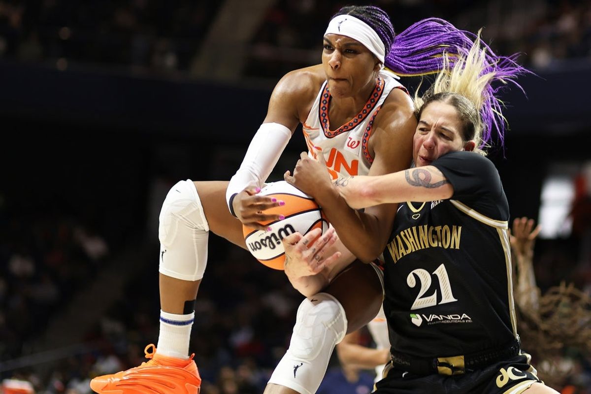 Aug 19, 2025; Washington, District of Columbia, USA; Connecticut Sun forward Aaliyah Edwards (8) grabs a rebound over Washington Mystics forward Emily Engstler (21) during the second half at CareFirst Arena. Mandatory Credit: Daniel Kucin Jr.-Imagn Images