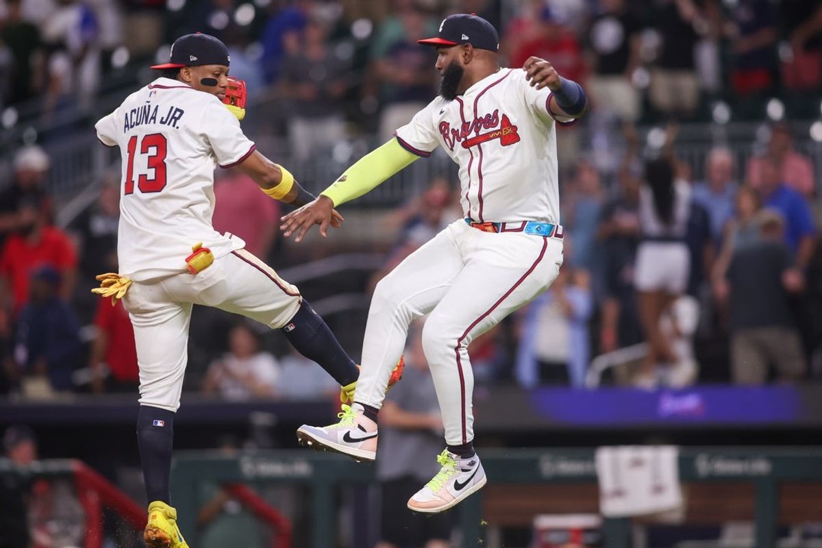 Aug 19, 2025; Atlanta, Georgia, USA; Atlanta Braves right fielder Ronald Acuna Jr. (13) and designated hitter Marcell Ozuna (20) celebrate after a victory over the Chicago White Sox at Truist Park. Mandatory Credit: Brett Davis-Imagn Images