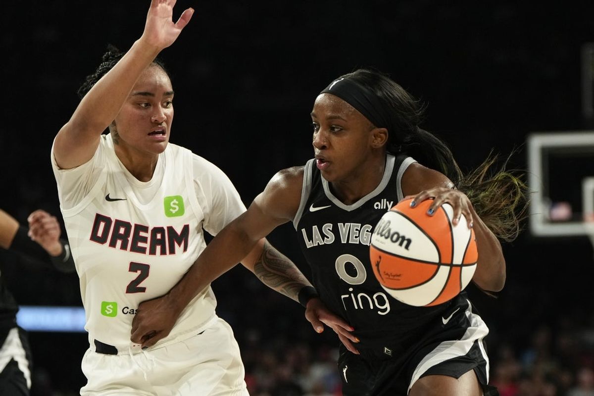 Aug 19, 2025; Las Vegas, Nevada, USA; Las Vegas Aces guard Jackie Young (0) drives the ball against Atlanta Dream guard Te-Hina Paopao (2) during the first half of a WNBA basketball game at Michelob Ultra Arena. Mandatory Credit: Lucas Peltier-Imagn Images