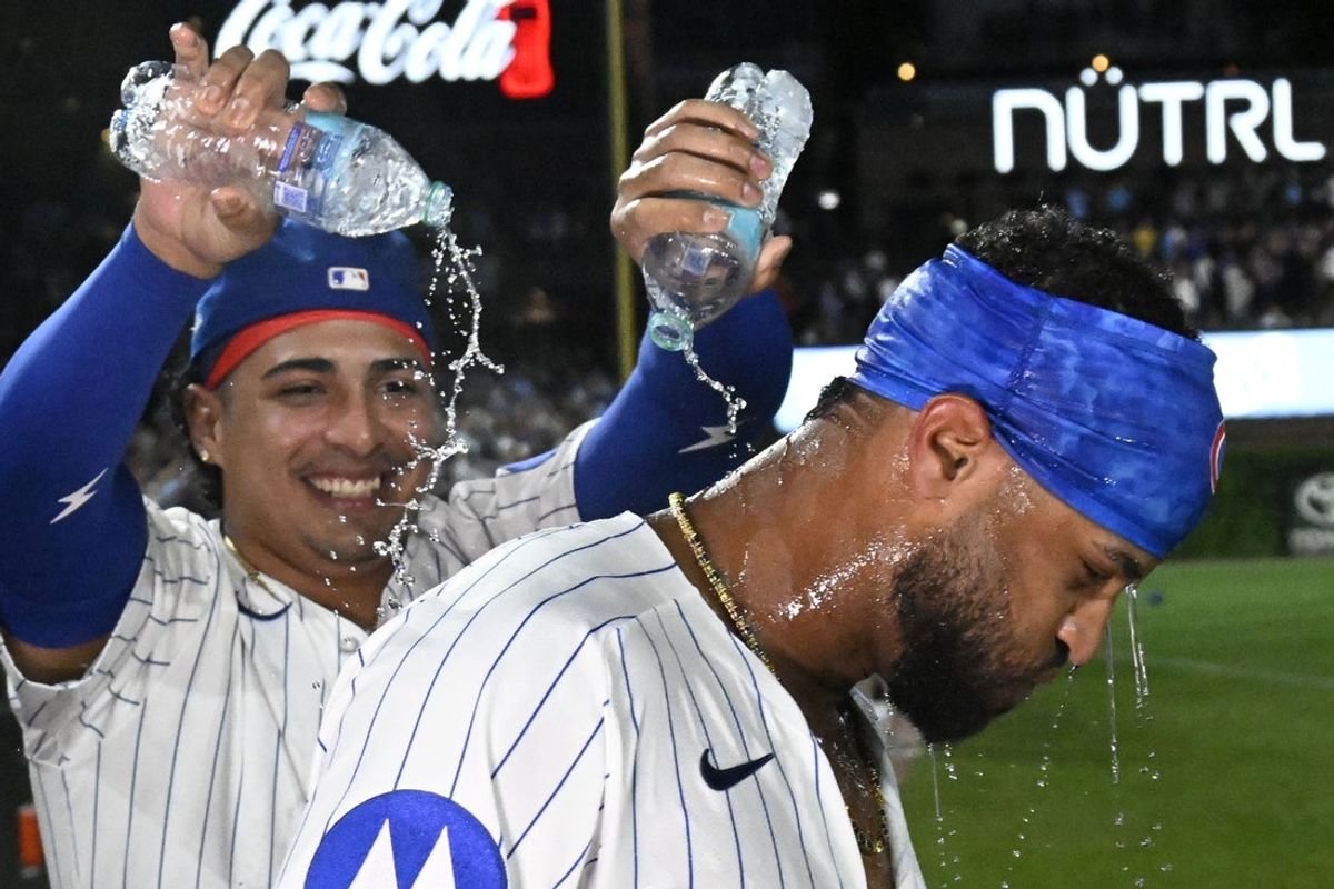 Aug 19, 2025; Chicago, Illinois, USA;  Chicago Cubs pitcher Daniel Palencia (48) douses  outfielder Willi Castro (1) after the game against the Milwaukee Brewers at Wrigley Field. Mandatory Credit: Matt Marton-Imagn Images