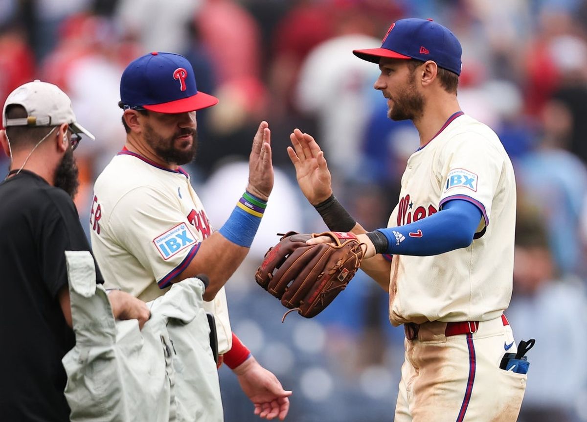 Aug 20, 2025; Philadelphia, Pennsylvania, USA; Philadelphia Phillies designated hitter Kyle Schwarber (12) and shortstop Trea Turner (7) high five after a victory against the Seattle Mariners at Citizens Bank Park. Mandatory Credit: Bill Streicher-Imagn Images