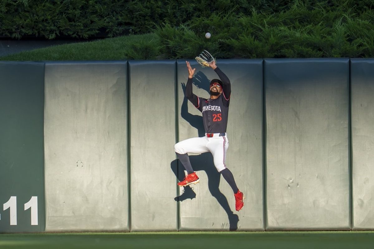 Aug 20, 2025; Minneapolis, Minnesota, USA; Minnesota Twins center fielder Byron Buxton (25) catches a fly ball against the Athletics in the second inning at Target Field. Mandatory Credit: Jesse Johnson-Imagn Images