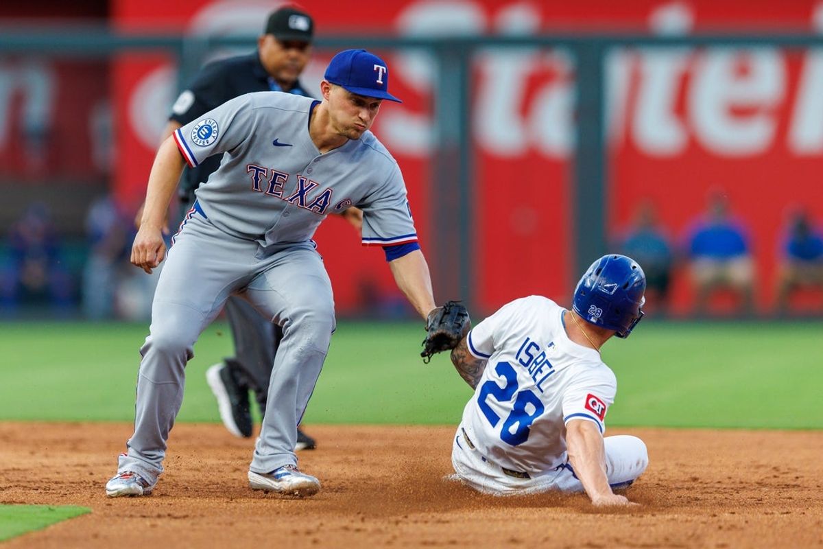 Aug 20, 2025; Kansas City, Missouri, USA;  Texas Rangers shortstop Corey Seager (5) tags Kansas City Royals outfielder Kyle Isbel (28) at second base during the second inning at Kauffman Stadium. Mandatory Credit: William Purnell-Imagn Images
