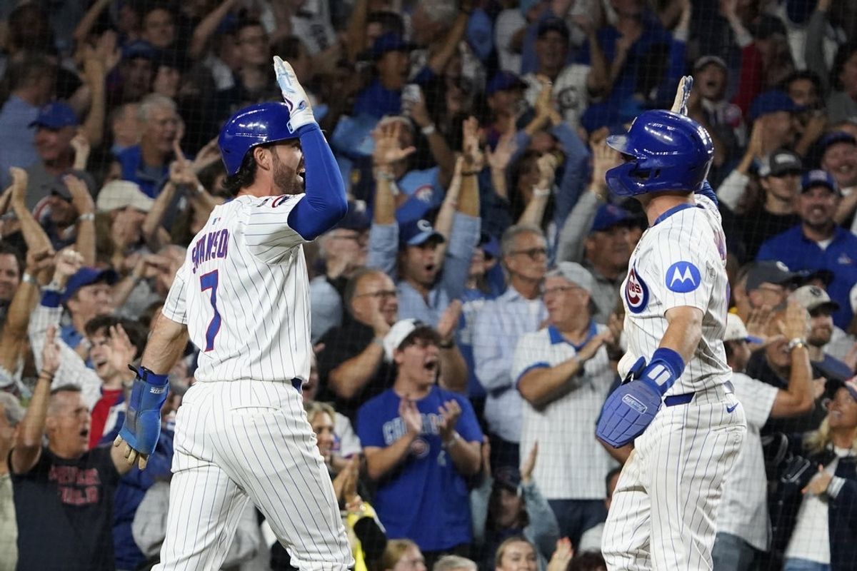 Aug 20, 2025; Chicago, Illinois, USA; Chicago Cubs shortstop Dansby Swanson (7) and third base Matt Shaw (6) celebrate after scoring against the Milwaukee Brewers during the third inning at Wrigley Field. Mandatory Credit: David Banks-Imagn Images