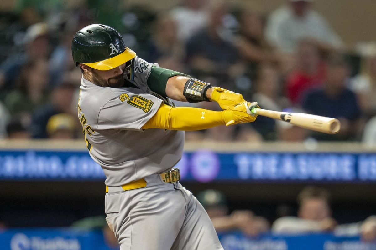 Aug 20, 2025; Minneapolis, Minnesota, USA; Athletics catcher Shea Langeliers (23) hits a two run home run in the tenth inning against the Minnesota Twins  at Target Field. Mandatory Credit: Jesse Johnson-Imagn Images